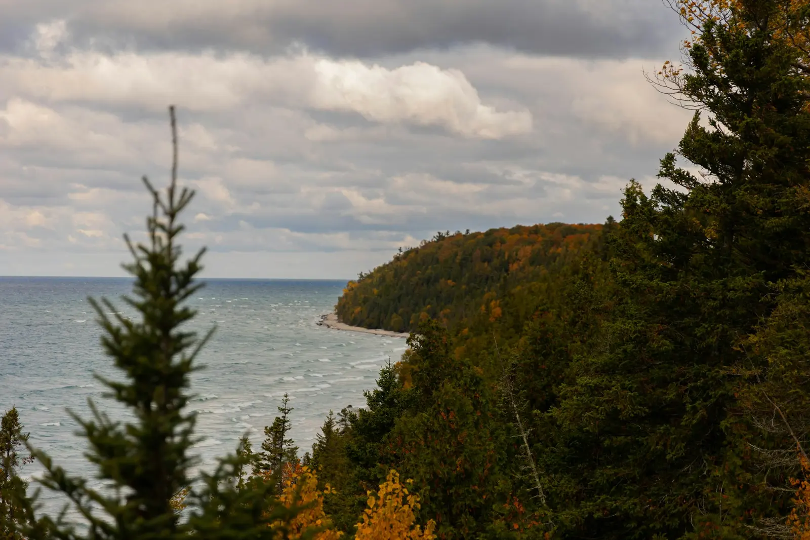 A lake framed by trees in autumn colour