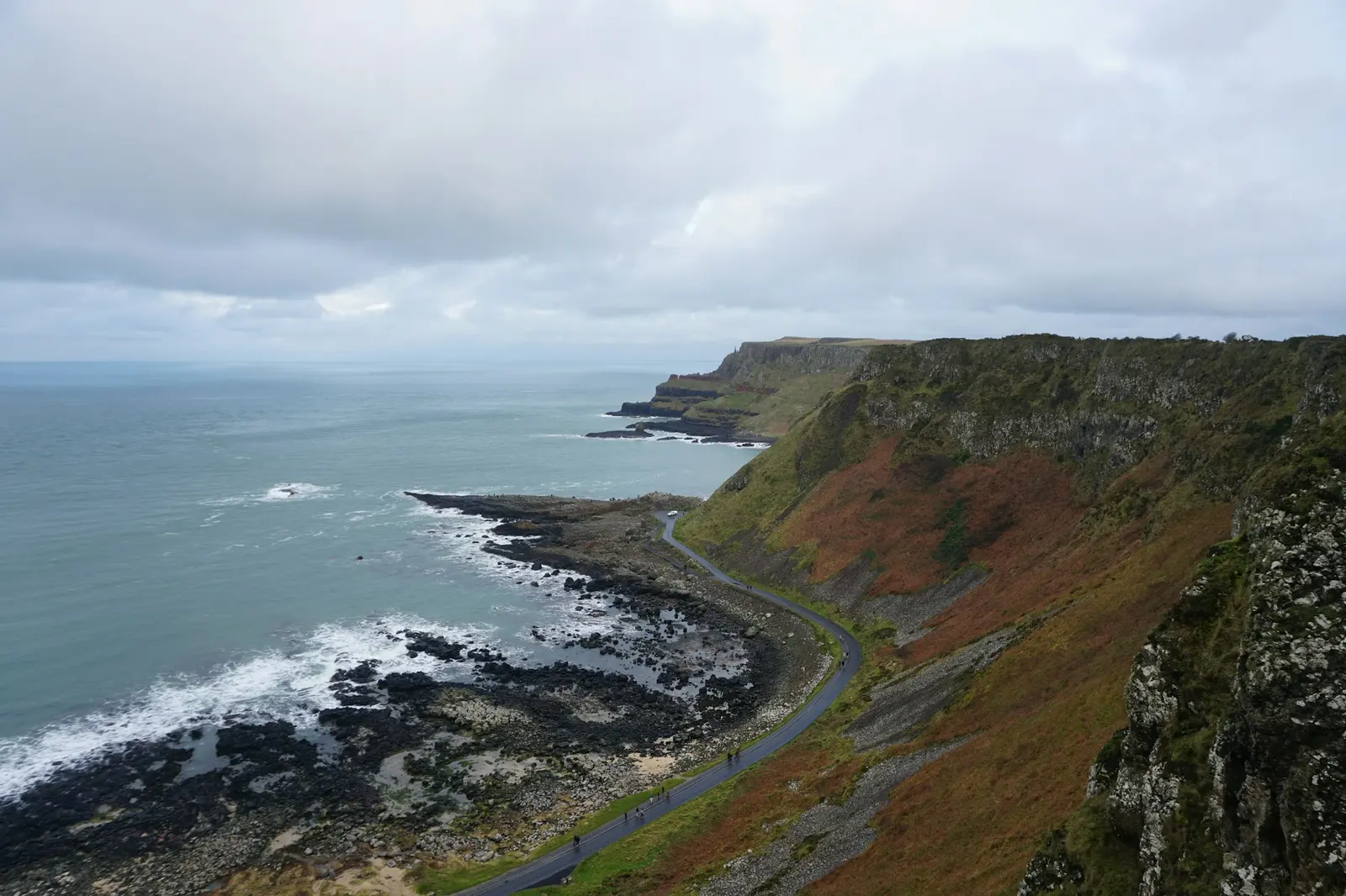A coastal road winding along rugged cliffs above the sea